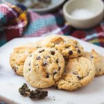 vegan cannabutter cookies on a marble slab with marijuana in front