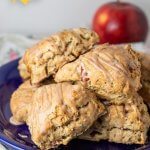 A pile of frosted scones on a plate