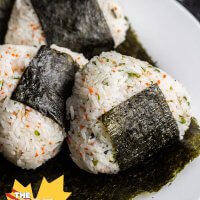 three onigiri on a sheet of nori on a plate
