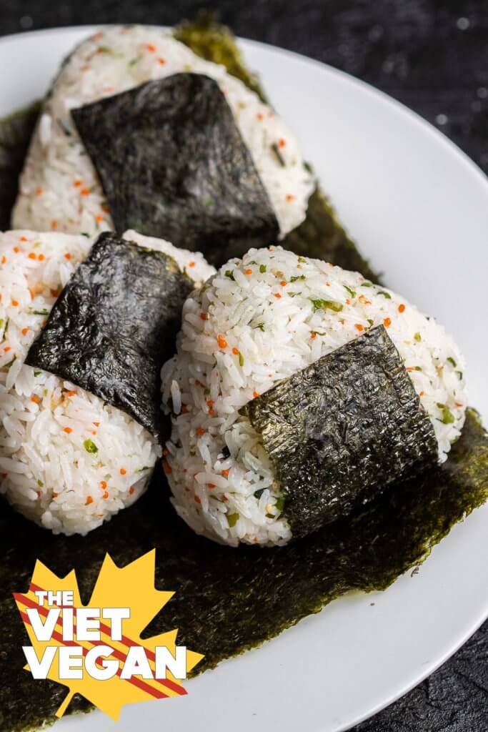 three onigiri on a sheet of nori on a plate