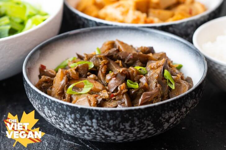 braised eggplant in a black and white bowl