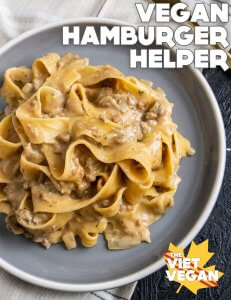 a serving of the finished pasta with parpadelle on a grey plate, on top of a beige plaid tea towel