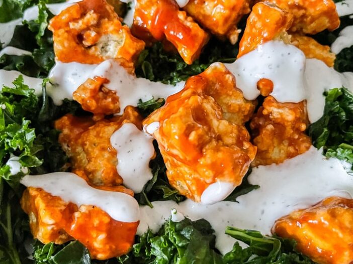 buffalo ranch tofu on a bed of massaged kale