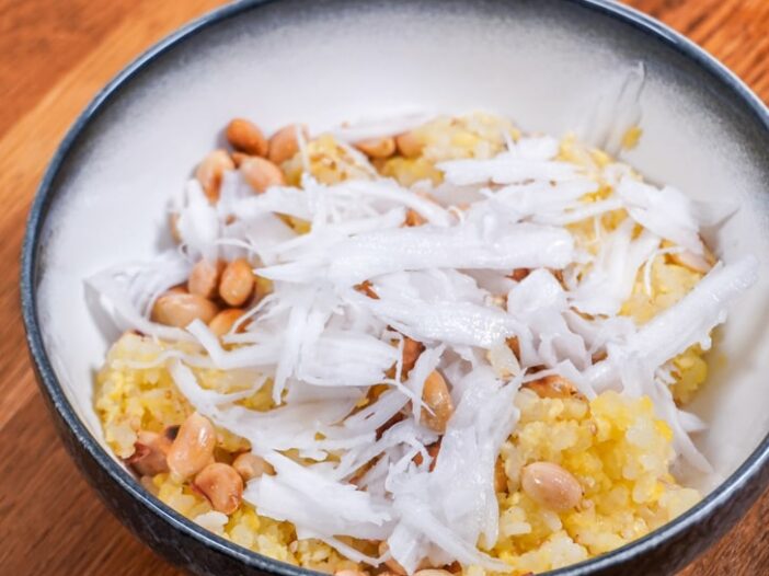 Sticky rice in a bowl with peanuts, sesame seeds and fresh coconut meat