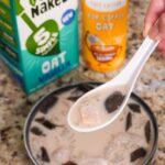 an asian soupspoon filled with taro, sago, grass jelly and sweetened oat milk