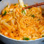 tteokkbokki and ramyun in a creamy carbonara gochujan sauce