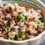 close up of lentil barley rice with peas in a cream scalloped bowl