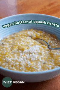vegan butternut squash risotto in a blue bowl topped with vegan parmesan