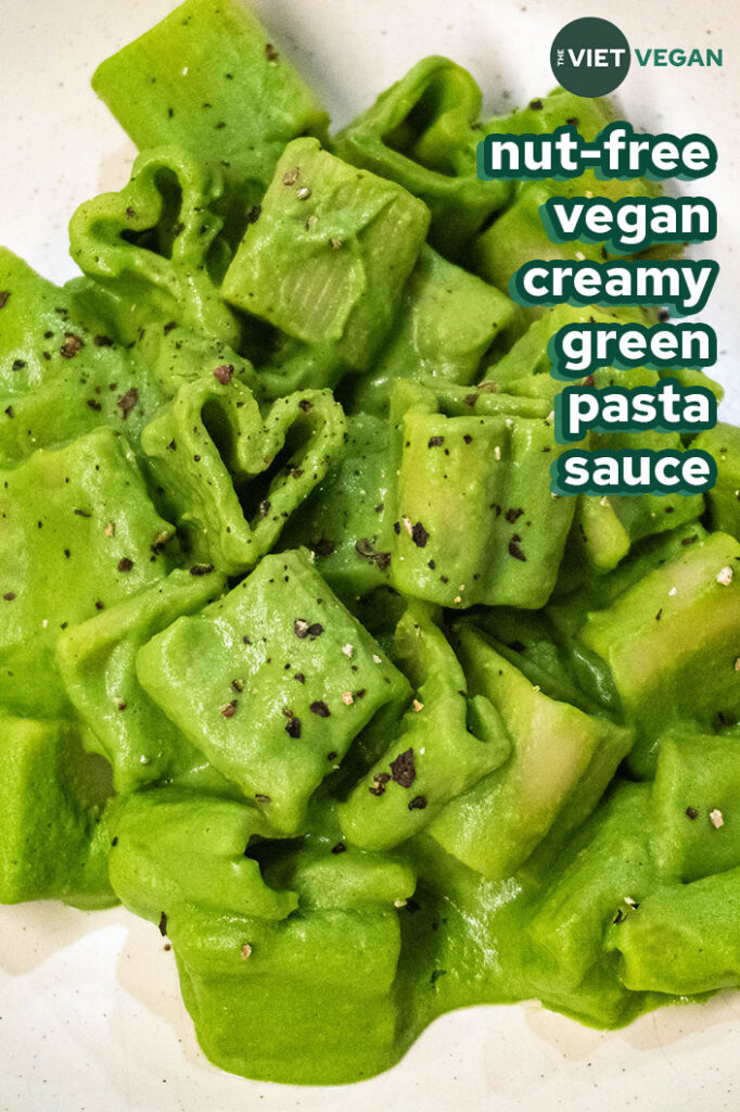 heart shaped pasta in a creamy green pasta sauce on a cream coloured plate