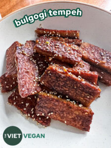 Bulgogi tempeh in a pan, garnished with sesame seeds