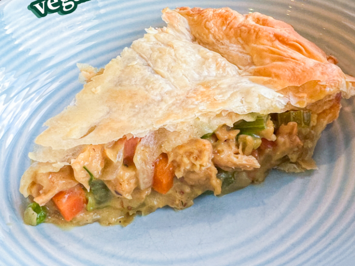 slice of vegan chicken pot pie in a blue bowl