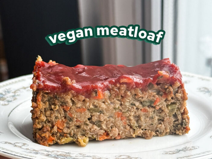 a slice of vegan meatloaf on a plate with a spicy ketchup glaze on top with the words "vegan meatloaf" overhead