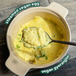 a scoop of the steamed vegan egg in a spoon over a casserole dish of the rest of the steamed egg