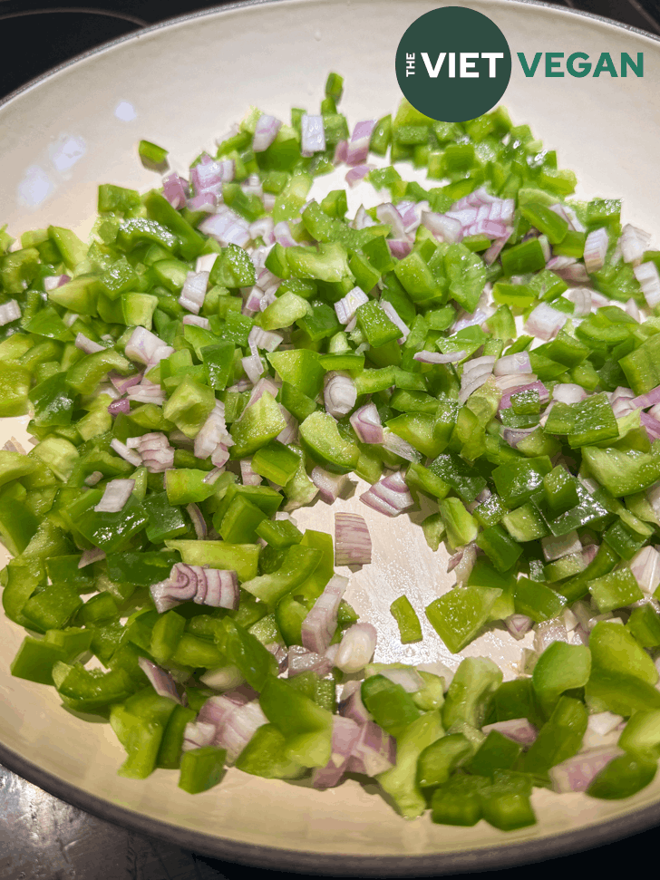 green bell peppers and onions in a pan
